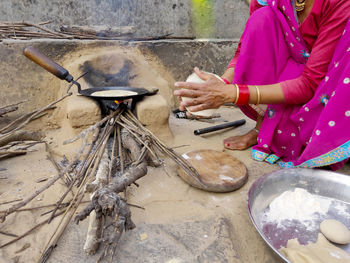 Low section of woman making chapati