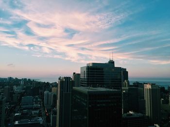 Buildings in city at sunset