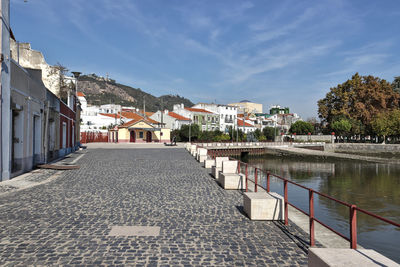 River amidst buildings against sky in city