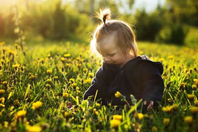 Rear view of baby girl on grassy field