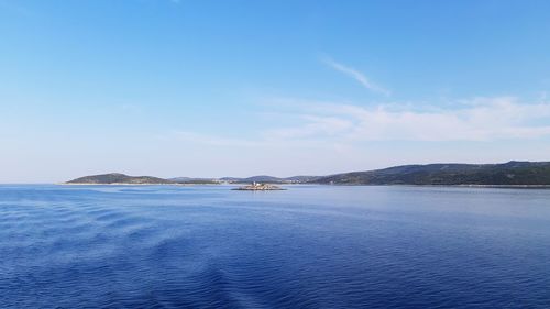Scenic view of sea against blue sky