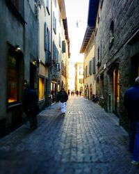 Rear view of people walking on street