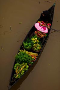 High angle view of person selling fruits in boat on canal