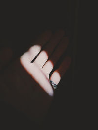 Close-up of human hand against black background