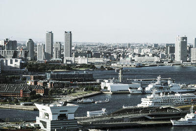 Aerial view of modern buildings in city against clear sky