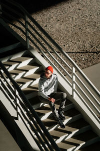 High angle view of man sitting on staircase