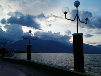 View of calm sea against mountain range