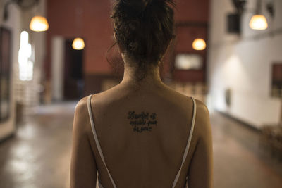 Rear view of woman with illuminated lighting equipment at night