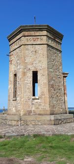 Low angle view of historical building against clear blue sky