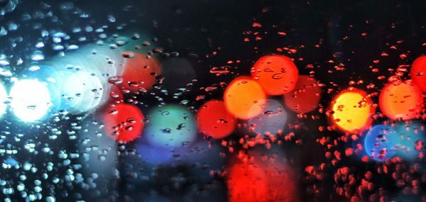 Full frame shot of wet glass window in rainy season