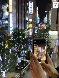 Cropped hand of man using mobile phone