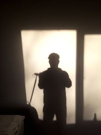 Silhouette man standing in bathroom