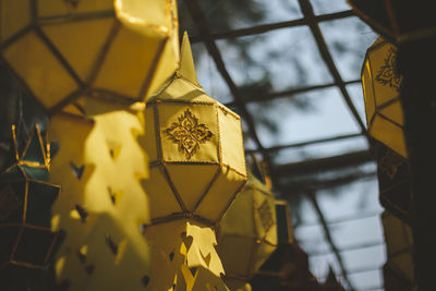 Low angle view of illuminated lanterns hanging on ceiling