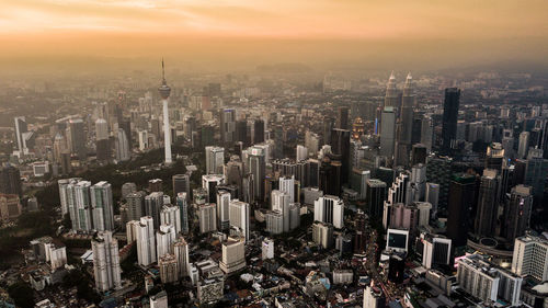 High angle view of modern buildings against sky during sunset