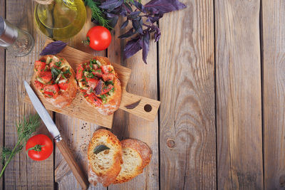 Italian bruschetta with chopped tomatoes, basil, herbs and olive oil on grilled crusty bread