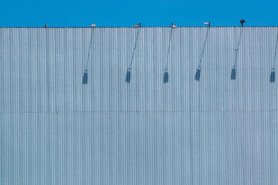 Low angle view of wall against blue sky