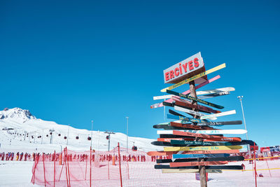 Low angle view of information sign against clear blue sky