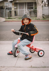 Portrait of cute boy riding motorcycle