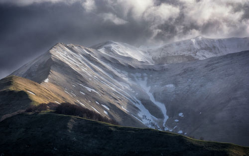 Scenic view of snowcapped mountains against sky