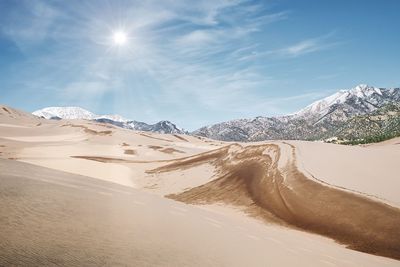 Scenic view of snowcapped mountains against sky