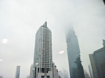 Low angle view of buildings against sky in city