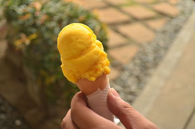 Close-up of hand holding ice cream