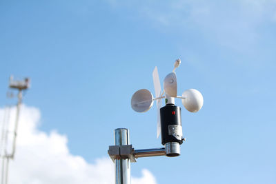 Low angle view of electric light against blue sky
