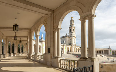 Fatima, portugal. the sanctuary of our lady of the rosary of fátima is viewed through the colonnade. 