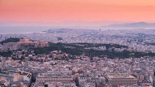 Aerial view of cityscape against sky during sunset