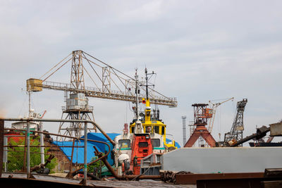 Old rusty cranes and steamers in the port