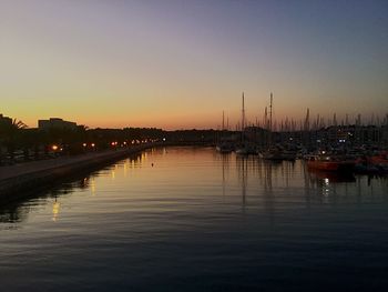 Sailboats in marina at sunset