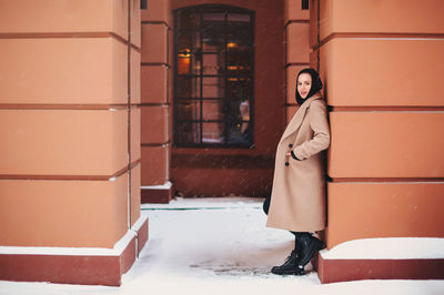 Portrait of woman standing in snow