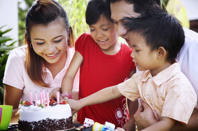 Family celebrating birthday in lawn