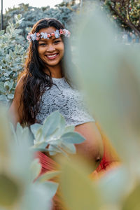 Portrait of smiling pregnant woman at park