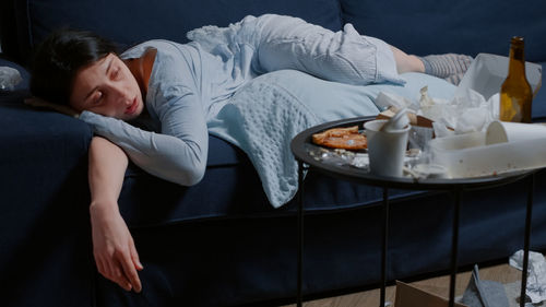 Portrait of woman sitting on sofa at home