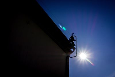 Low angle view of illuminated lamp against clear sky