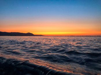 Scenic view of sea against clear sky during sunset