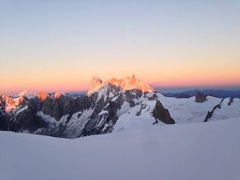 Scenic view of snowcapped mountains against sky during sunset