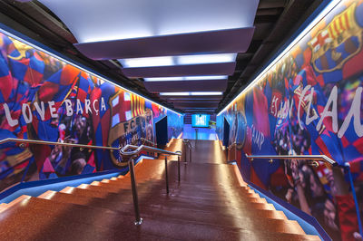 People in illuminated corridor of building