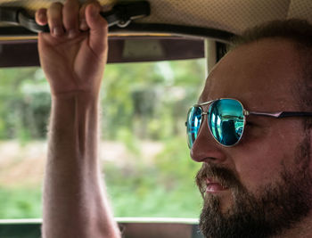 Close-up of man wearing sunglasses in car