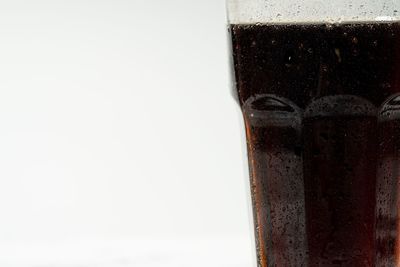 Close-up of beer glass against white background