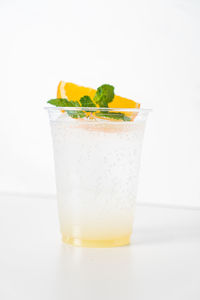 Close-up of drink in glass against white background