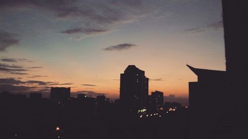 Buildings in city at sunset