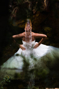 Close-up of flowing water with bride in background