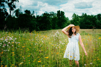 Woman walking among pink flowers in a meadow