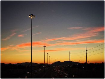 Silhouette street light against sky during sunset