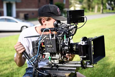 Man photographing on field