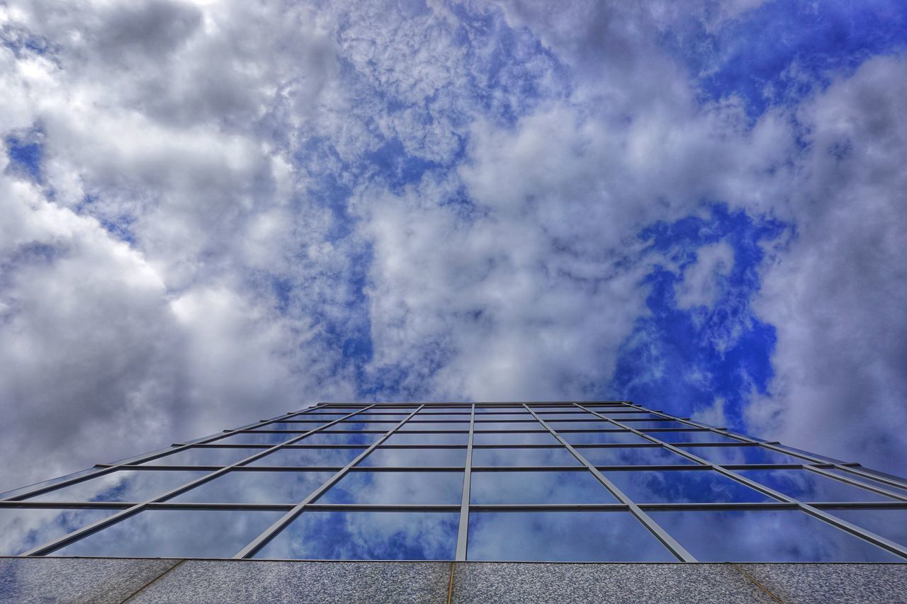 architecture, built structure, building exterior, low angle view, sky, cloud - sky, cloudy, modern, cloud, building, city, office building, glass - material, day, weather, outdoors, overcast, tall - high, no people, tower