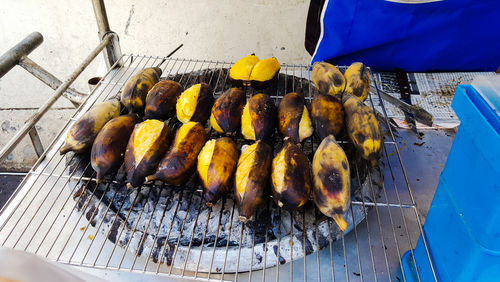 High angle view of meat on barbecue grill