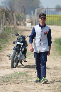 Portrait of happy man standing on road